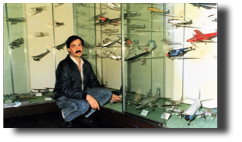 Museo Naval de la Nación. Guillermo Rojas Bazán posing next to the display cases with his collection of 87 models in 1986.